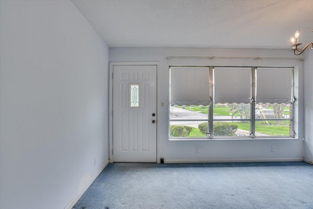 foyer featuring carpet floors and a textured ceiling