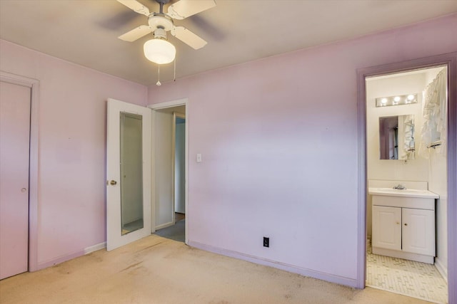 unfurnished bedroom with connected bathroom, ceiling fan, sink, and light colored carpet