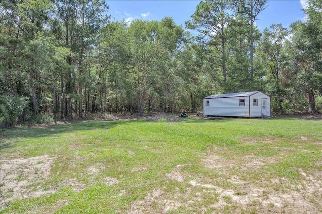 4921 Mossycup Ct, Hephzibah, GA 30815 - view of grassy yard with an outdoor structure and a wooded view