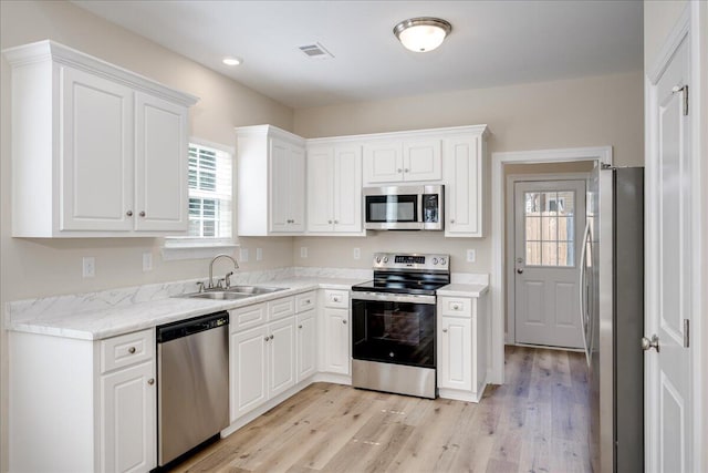 4921 Mossycup Ct, Hephzibah, GA 30815 - kitchen featuring appliances with stainless steel finishes, healthy amount of natural light, light wood-style flooring, and recessed lighting