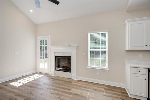 4921 Mossycup Ct, Hephzibah, GA 30815 - unfurnished living room with a ceiling fan, light wood finished floors, a fireplace, and vaulted ceiling