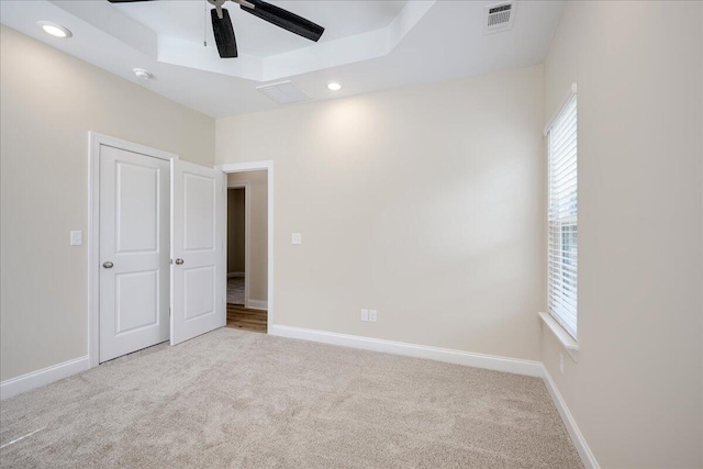 4921 Mossycup Ct, Hephzibah, GA 30815 - unfurnished bedroom with carpet floors, multiple windows, a tray ceiling, recessed lighting, and a ceiling fan