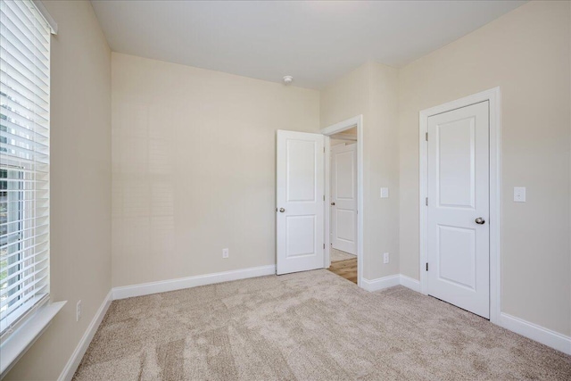 4921 Mossycup Ct, Hephzibah, GA 30815 - unfurnished bedroom featuring carpet and multiple windows