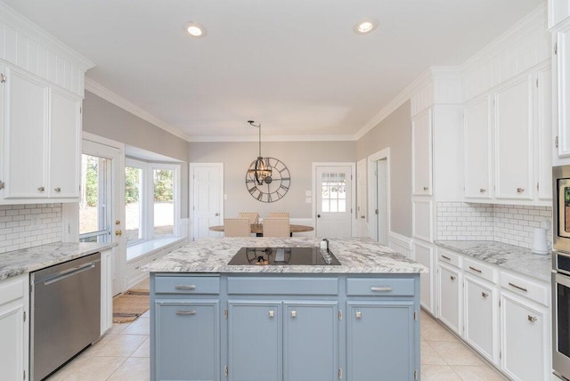 kitchen featuring blue cabinetry, stainless steel appliances, a center island, and white cabinetry