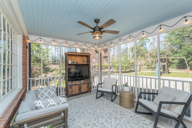 sunroom featuring ceiling fan and wooden ceiling