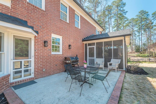 view of patio / terrace with outdoor dining area, a sunroom, and grilling area