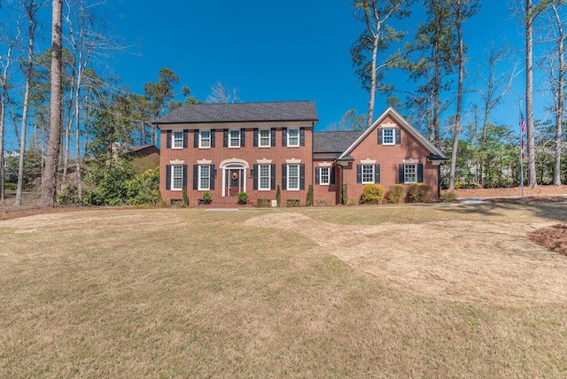 view of front of home featuring a front yard and brick siding