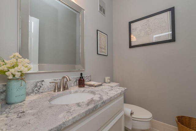 bathroom with visible vents, baseboards, toilet, and vanity