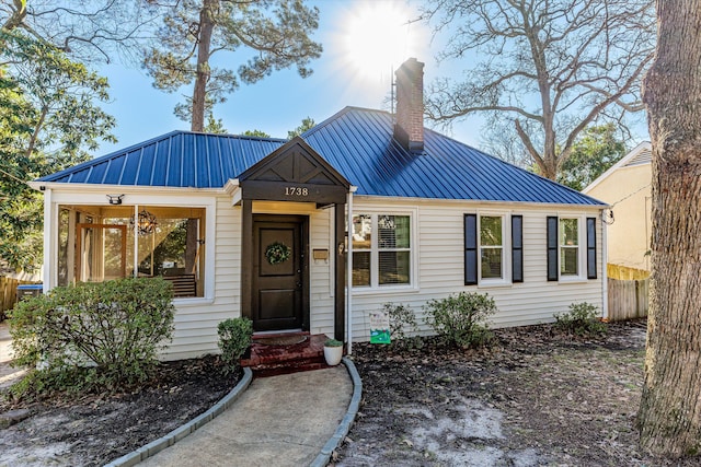 1738 Kissingbower Rd, Augusta, GA 30904 - view of front facade featuring a chimney, a metal roof, and a standing seam roof