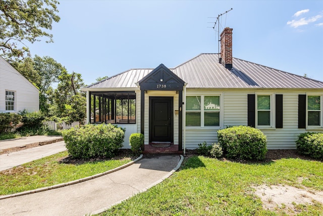 1738 Kissingbower Rd, Augusta, GA 30904 - view of front of home with a chimney, a metal roof, and a front lawn