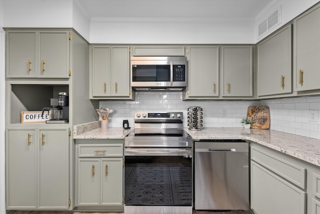 1738 Kissingbower Rd, Augusta, GA 30904 - kitchen with stainless steel appliances, crown molding, decorative backsplash, light stone counters, and gray cabinetry