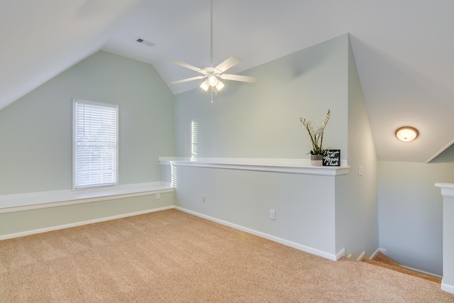 bonus room with lofted ceiling, visible vents, carpet flooring, ceiling fan, and baseboards