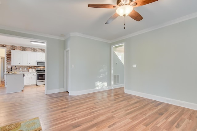 unfurnished living room featuring crown molding and light wood finished floors