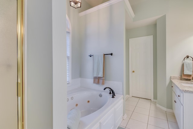 full bath with tile patterned floors, baseboards, a tub with jets, and vanity