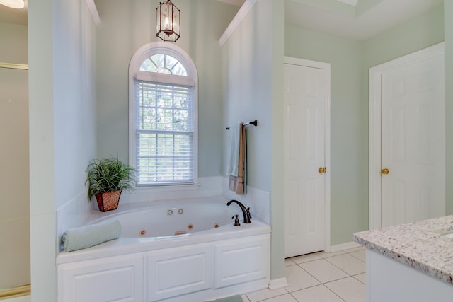 full bath with a jetted tub, tile patterned flooring, vanity, and a healthy amount of sunlight