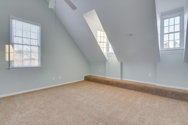 additional living space with ceiling fan, baseboards, vaulted ceiling, and carpet flooring