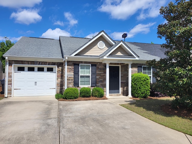 view of front of house with stone siding, roof with shingles, driveway, and an attached garage