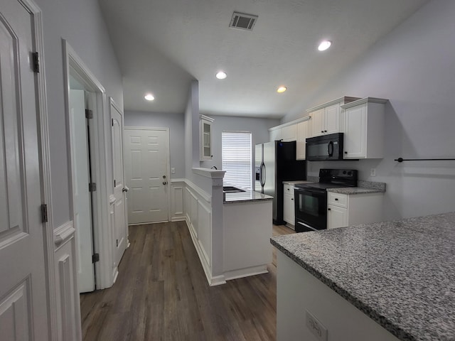 kitchen with white cabinetry, visible vents, black appliances, dark wood-style flooring, and wainscoting
