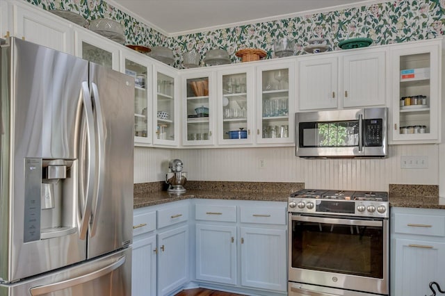 1958 Mcdowell St, Augusta, GA 30904 - kitchen featuring stainless steel appliances, crown molding, white cabinets, glass insert cabinets, and dark stone countertops