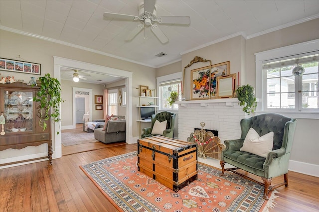 1958 Mcdowell St, Augusta, GA 30904 - living room with a ceiling fan, wood-type flooring, a fireplace, baseboards, and crown molding