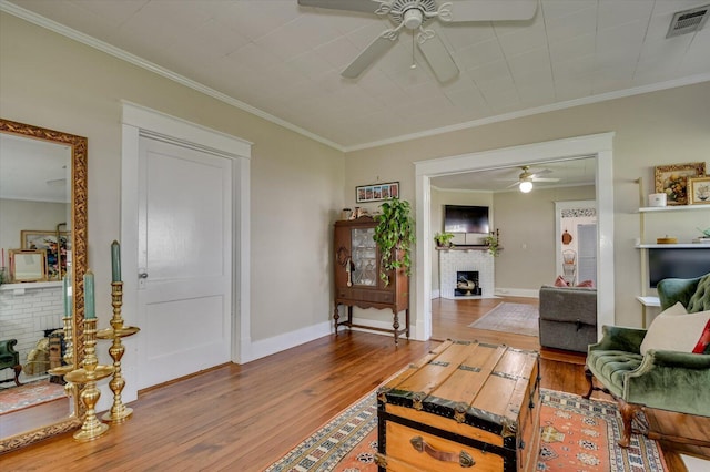 1958 Mcdowell St, Augusta, GA 30904 - living area with ceiling fan, a fireplace, hardwood / wood-style floors, crown molding, and baseboards