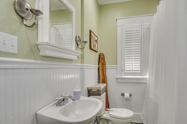 1958 Mcdowell St, Augusta, GA 30904 - bathroom with a sink, a wainscoted wall, toilet, and a shower with shower curtain