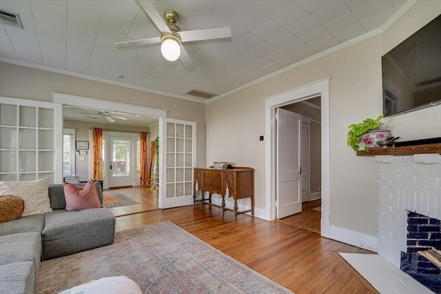 1958 Mcdowell St, Augusta, GA 30904 - living area featuring a ceiling fan, wood finished floors, french doors, a brick fireplace, and crown molding
