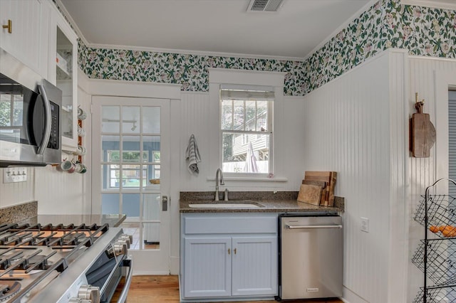 1958 Mcdowell St, Augusta, GA 30904 - kitchen featuring a sink, stainless steel appliances, crown molding, healthy amount of natural light, and dark stone counters