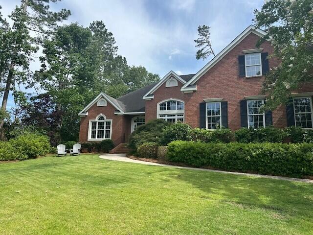 3218 Ramsgate Rd, Augusta, GA 30909 - traditional-style home featuring a front lawn and brick siding