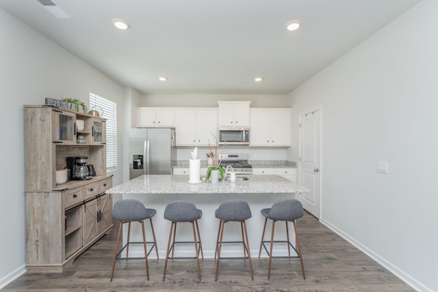 6058 Whitewater Dr, North Augusta, SC 29841 - kitchen with appliances with stainless steel finishes, a kitchen breakfast bar, a center island with sink, open shelves, and recessed lighting