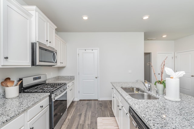 6058 Whitewater Dr, North Augusta, SC 29841 - kitchen with stainless steel appliances, dark wood-style floors, white cabinets, light stone counters, and recessed lighting