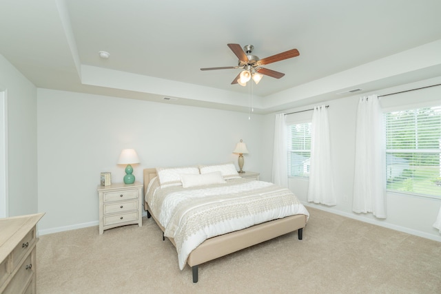 6058 Whitewater Dr, North Augusta, SC 29841 - bedroom with light colored carpet, a tray ceiling, and a ceiling fan