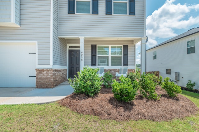 6058 Whitewater Dr, North Augusta, SC 29841 - doorway to property with covered porch and a garage