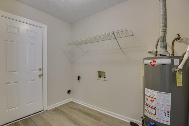 laundry area featuring gas water heater, hookup for a washing machine, light wood-type flooring, a textured ceiling, and hookup for an electric dryer