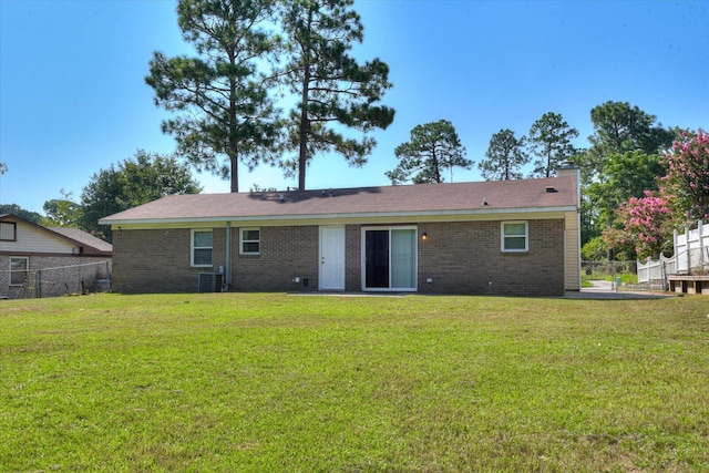 back of property featuring a yard and central AC unit