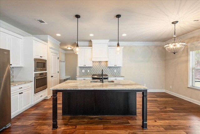 514 Windermere St, Evans, GA 30809 - kitchen with appliances with stainless steel finishes, a kitchen bar, backsplash, white cabinetry, and light stone countertops