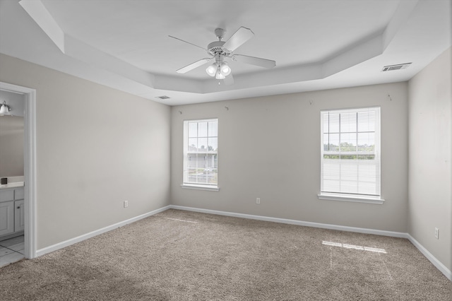 2807 Brickrun Way, Augusta, GA 30909 - unfurnished bedroom with a raised ceiling, carpet floors, connected bathroom, and a ceiling fan