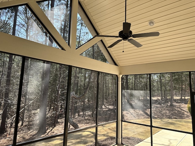 unfurnished sunroom with ceiling fan and vaulted ceiling