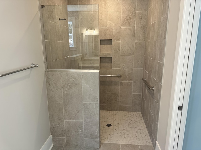 full bath featuring a tile shower