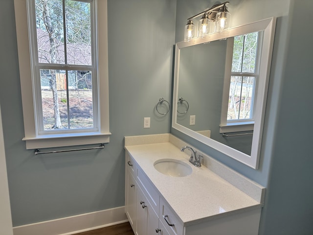 bathroom featuring baseboards and vanity