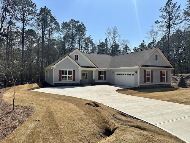 view of front of house featuring concrete driveway, a garage, and a front lawn