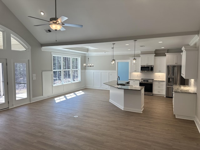 kitchen with ceiling fan with notable chandelier, a sink, open floor plan, white cabinetry, and appliances with stainless steel finishes