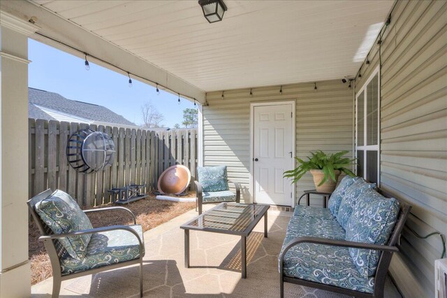 view of patio / terrace featuring outdoor lounge area and fence