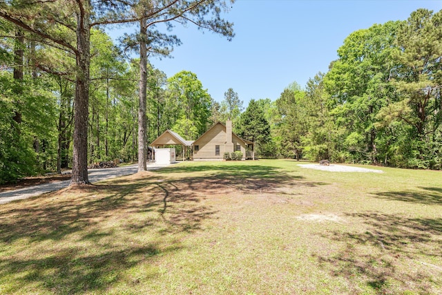view of yard with a forest view