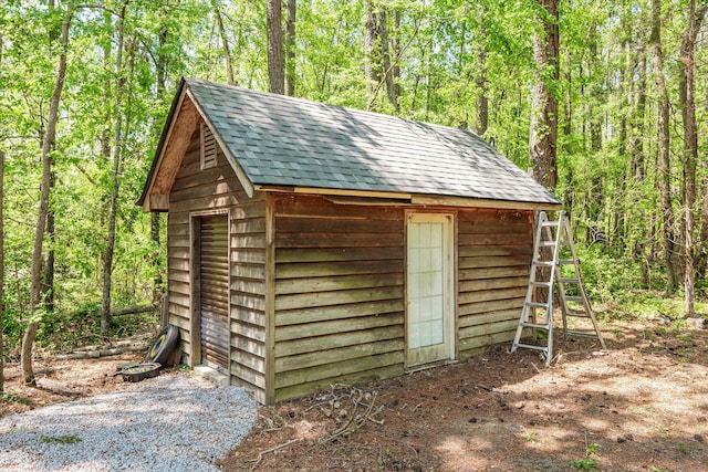 view of shed with a wooded view