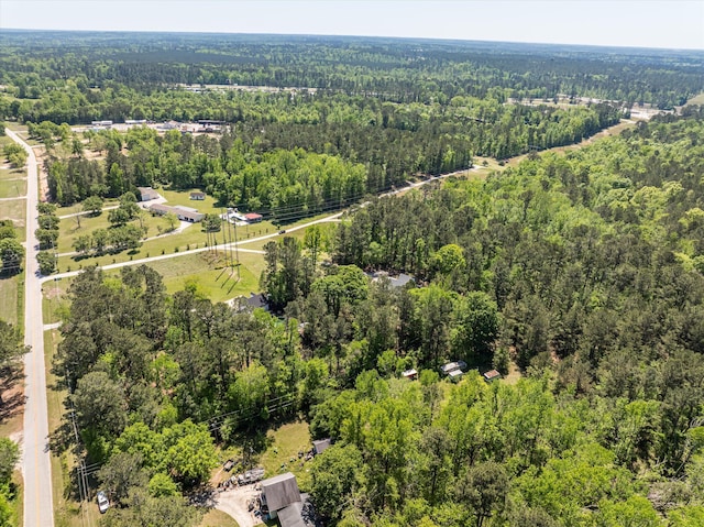 bird's eye view with a wooded view