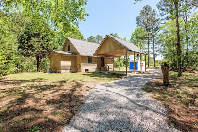 chalet / cabin featuring crawl space, driveway, and a shingled roof