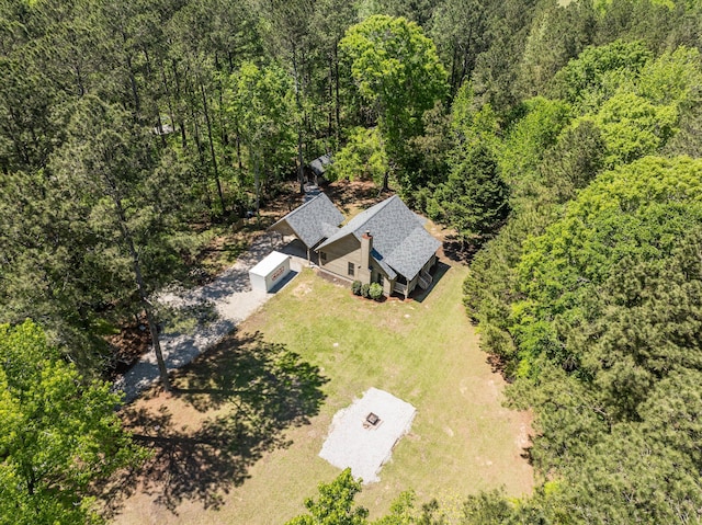 bird's eye view with a wooded view