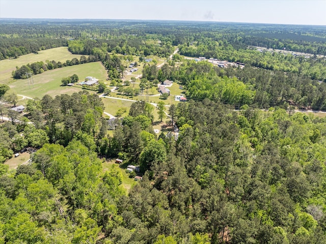 birds eye view of property with a wooded view