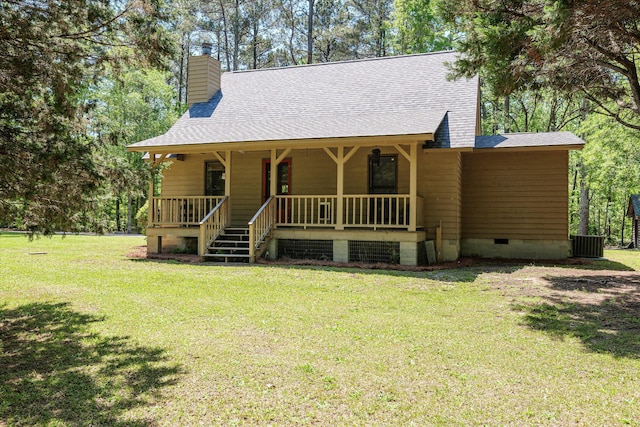chalet / cabin with a chimney, a shingled roof, crawl space, covered porch, and a front yard